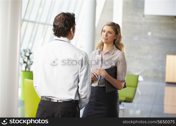 Businessman And Businesswoman Having Meeting In Office