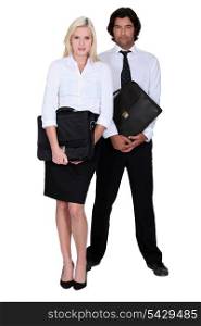businessman and businesswoman holding a briefcase