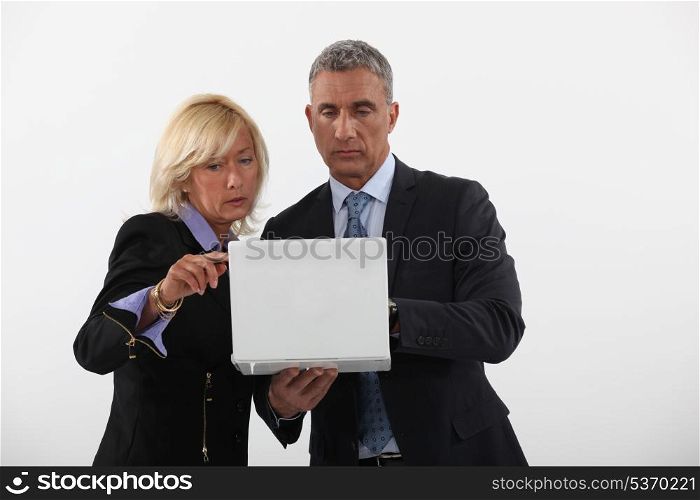 businessman and businesswoman holding a laptop