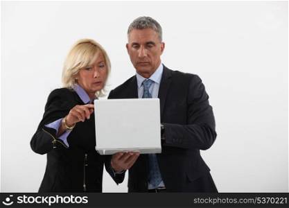 businessman and businesswoman holding a laptop