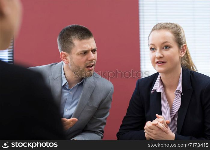 Businessman And Businesswoman In Mediation Meeting
