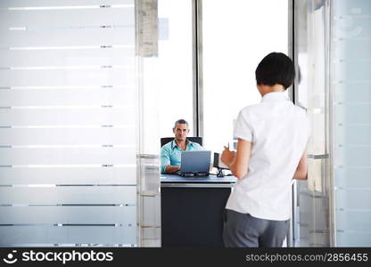 Businessman and Businesswoman in Office