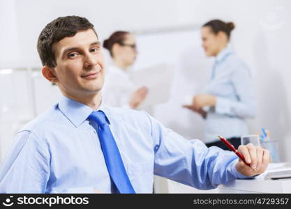 Businessman and businesswoman in office sitting at table and having conversation. Working in partnership