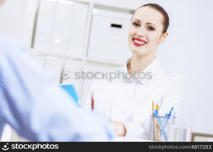 Businessman and businesswoman in office sitting at table and having conversation. Working in partnership