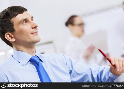 Businessman and businesswoman in office sitting at table and having conversation. Working in partnership