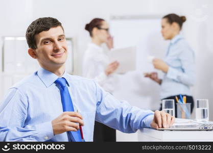 Businessman and businesswoman in office sitting at table and having conversation. Working in partnership