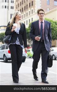 Businessman And Businesswoman In Street With Takeaway Coffee