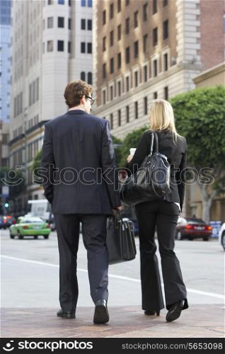 Businessman And Businesswoman In Street With Takeaway Coffee