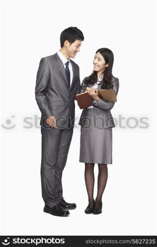 Businessman and businesswoman looking at each other