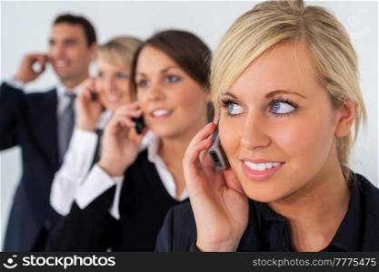 Businessman and businesswoman, male and female, talking on cell phones, business men and women team.