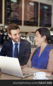 Businessman And Businesswoman Meeting In Coffee Shop