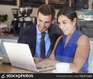 Businessman And Businesswoman Meeting In Coffee Shop