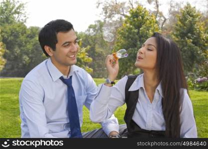 Businessman and businesswoman romancing in a park