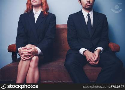 Businessman and businesswoman sitting on a sofa