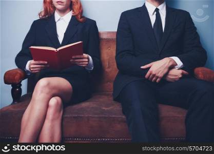 Businessman and businesswoman sitting on a sofa