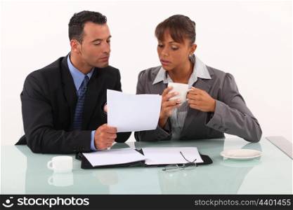 businessman and businesswoman working and drinking coffee