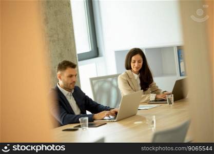 Businessman and businesswoman working together in office