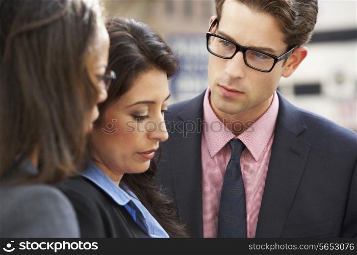 Businessman And Businesswomen Having Discussion In Street