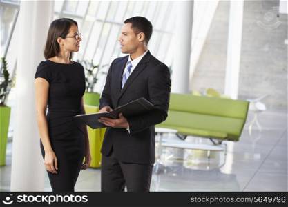 Businessman And Businesswomen Having Informal Meeting In Office