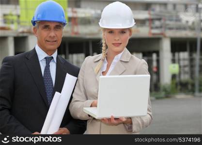 businessman and female assistant on a construction site