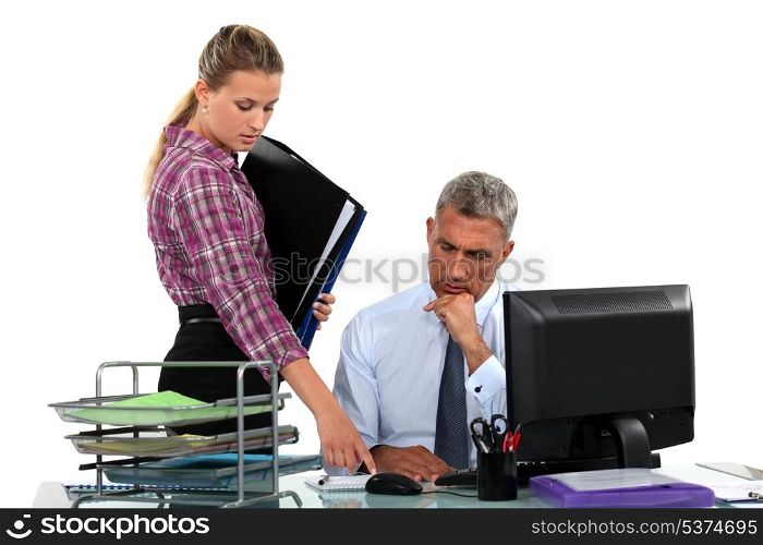 Businessman and his assistant at his desk