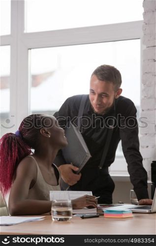 Businessman and his colleague at office working together