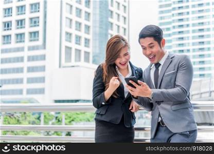Businessman and his secreatary are surprising when look at the smartphone, Business concept, Happiness concept, Technology concept