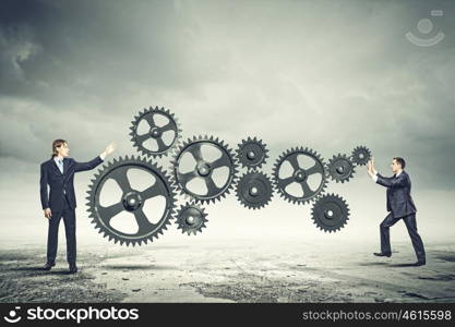 Businessman and mechanism elements. Businessman with cog wheel elements. Construction concept