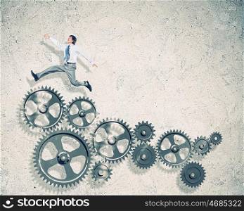 Businessman and mechanism elements. Businessman with cog wheel elements. Construction concept