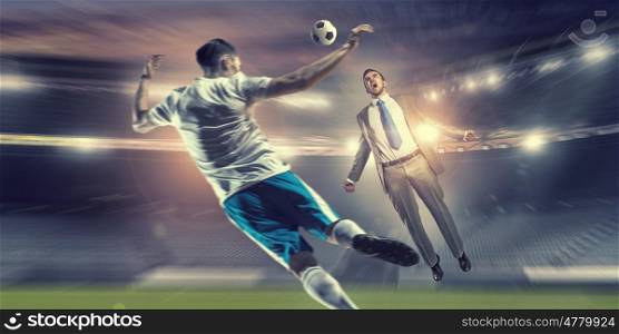 Businessman and player fighting for ball. Young businessman in suit playing football at stadium