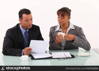 businessman and secretary consulting files