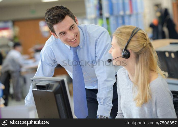 businessman and smiling secretary talking by phone