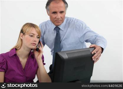 Businessman and woman at a computer