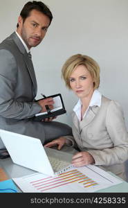 businessman and woman at desk