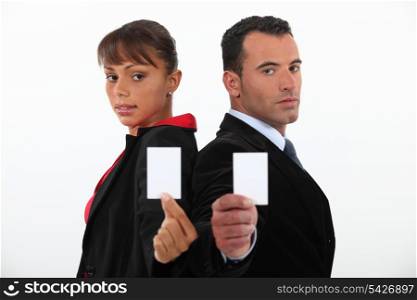 Businessman and woman holding calling cards