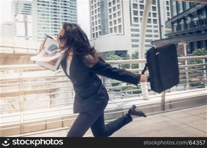 businessman and woman hurry up and running in business city street for rush hour as motion blur