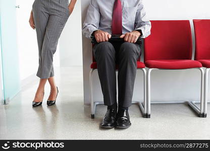 Businessman and Woman in Office Corridor