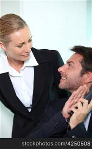 Businessman and woman looking into each other&acute;s eyes