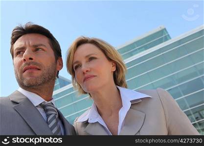 Businessman and woman outside.