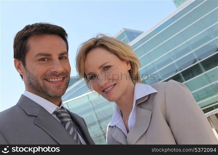 Businessman and woman outside.