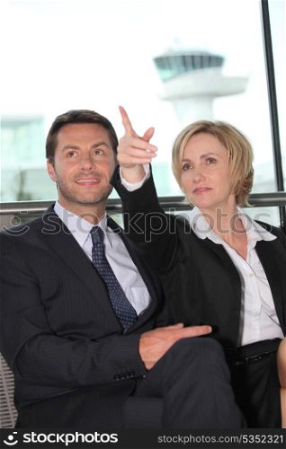 Businessman and woman pointing