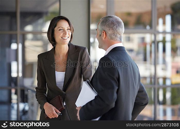 Businessman and woman talking.