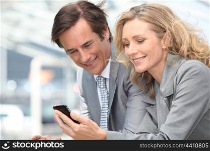 Businessman and woman with phone