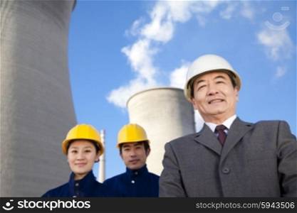 Businessman and workers in hardhats