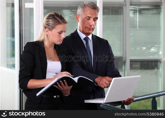 Businessman and young assistant rushing to prepare presentation