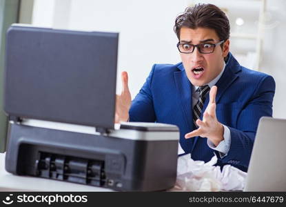 Businessman angry at copying machine jamming papers