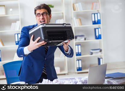 Businessman angry at copying machine jamming papers