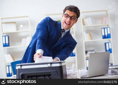 Businessman angry at copying machine jamming papers