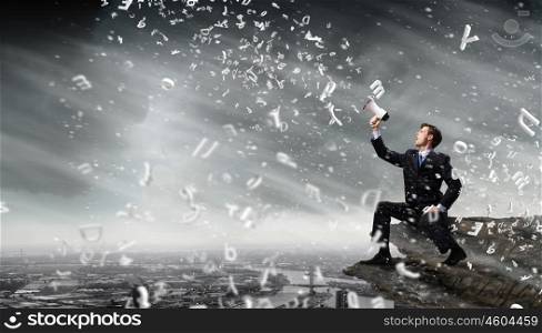 Businessman announcing something. Businessman sitting on rock edge and screaming in megaphone