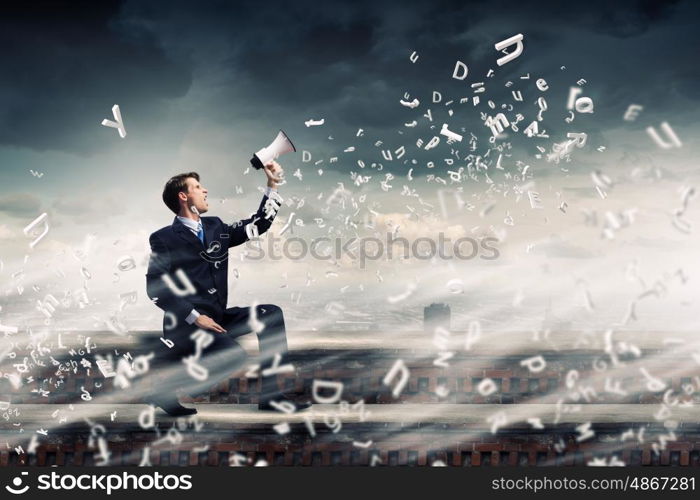 Businessman announcing something. Businessman sitting on rock edge and screaming in megaphone